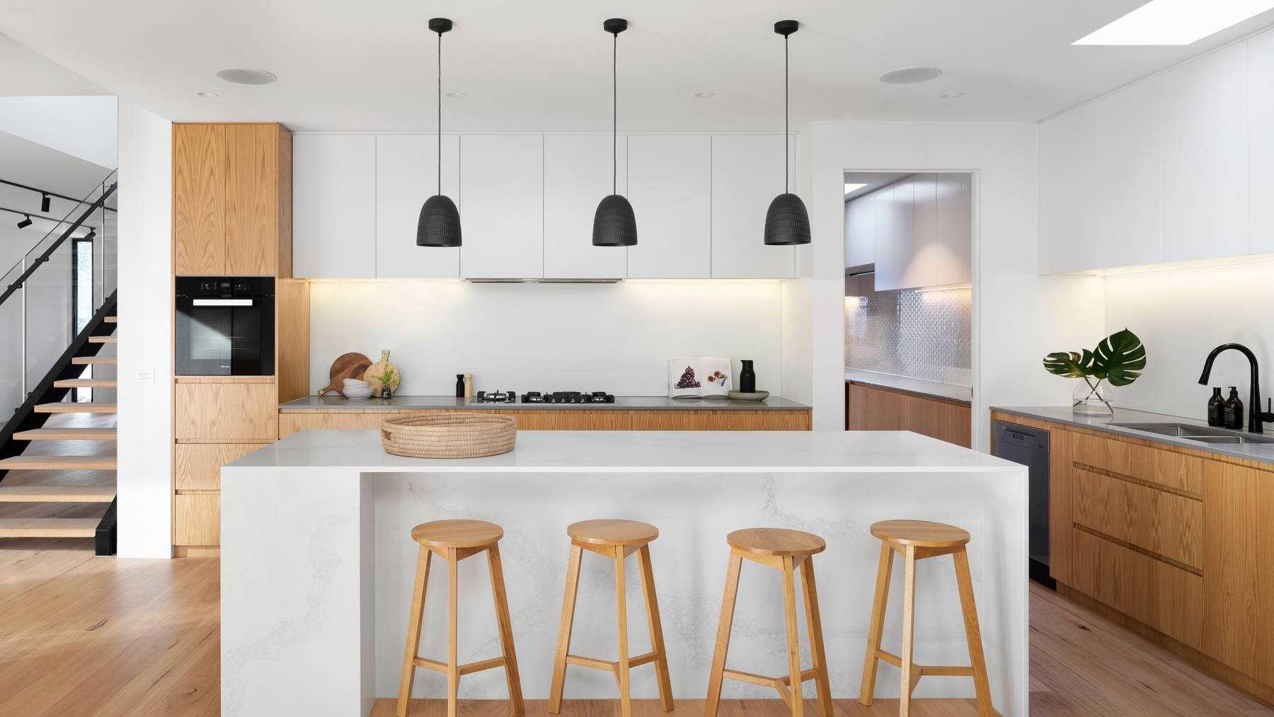 A white kitchen, decorated with with modern furnishings