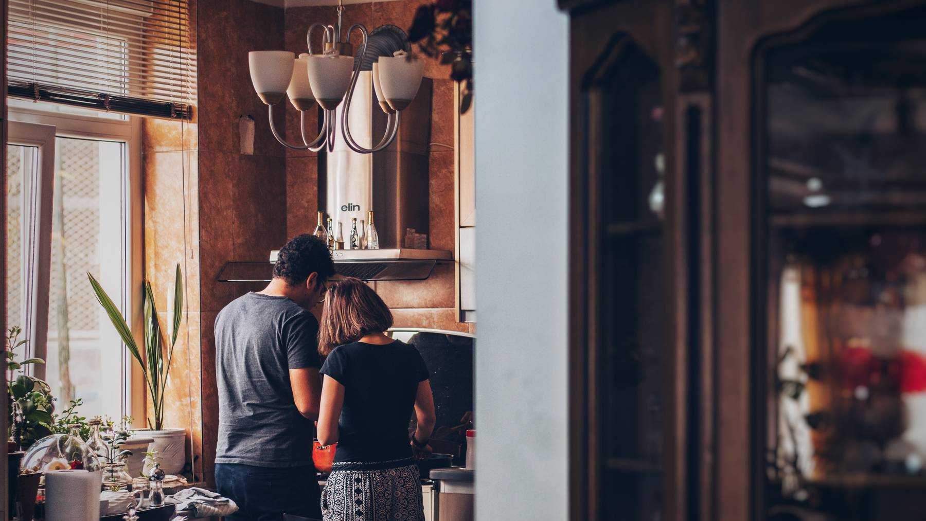 A couple standing together in their kitchen